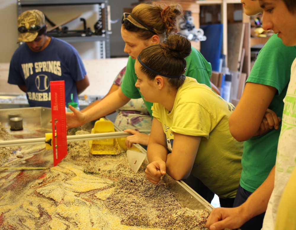 Members of the Youth Conservation Corps practice surveying in our Em3.